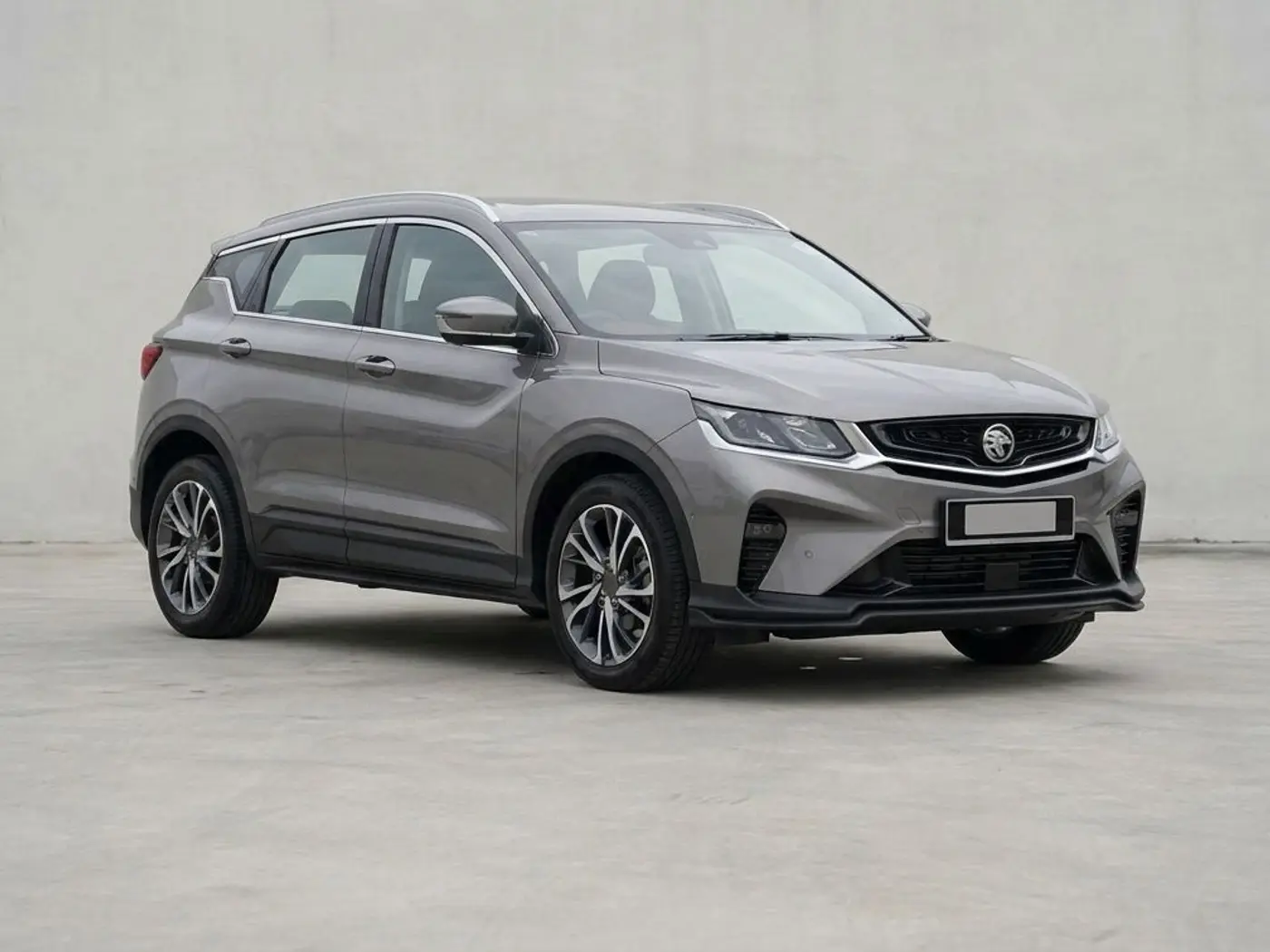 A grey Proton X50 SUV on a concrete forecourt